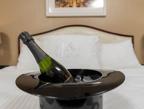 Champagne bottle in ice bucket in hotel room