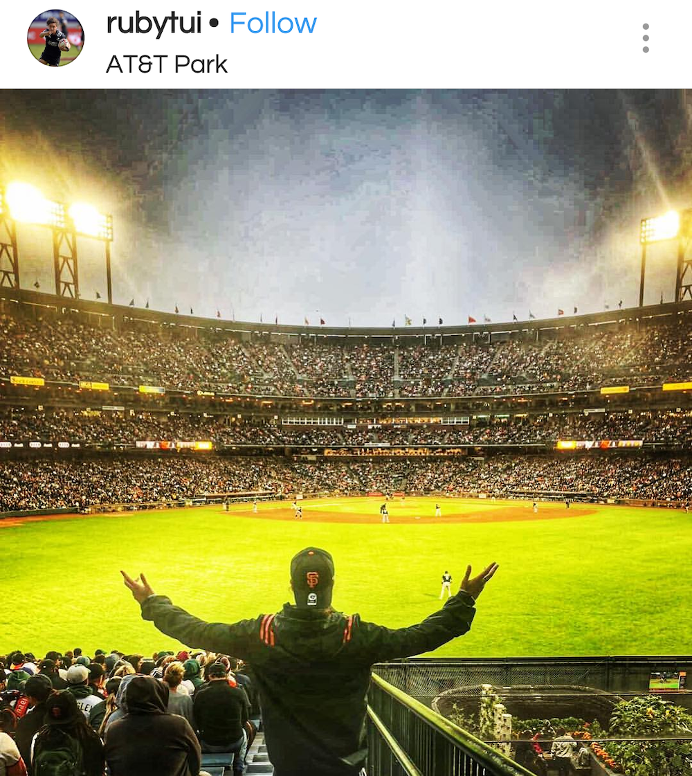 Man standing in front of AT&T baseball field