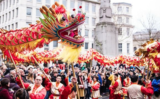 People marching with dragon for Chinese New Year